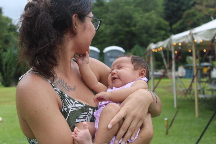 Mother holding and smiling with her baby in Hawaiʻi
